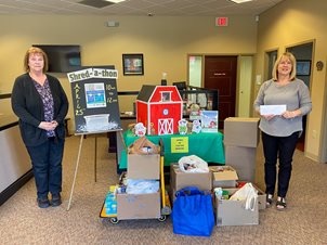 BFCU staff members standing in front of Cornerstone Health Clinic van filled with food that was donated