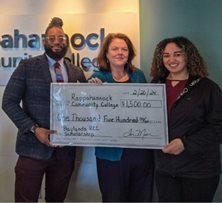 Credit Union members holding up a large check.