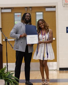 One of our staff members presenting the Scholarship Award to the winner. Campbell.