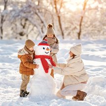 Family building a snowman together