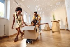 Image of family playing in their new home