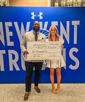 One of our staff members presenting the Scholarship Award to the winner. Campbell.