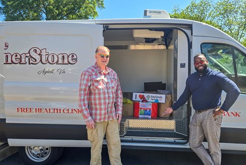 BFCU staff members standing in front of Cornerstone Health Clinic van filled with food that was donated