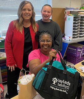 Picture of the Norge Branch supervisor with Ms Washington and one of her students with a few goodies they brought her for teacher appreciation day.